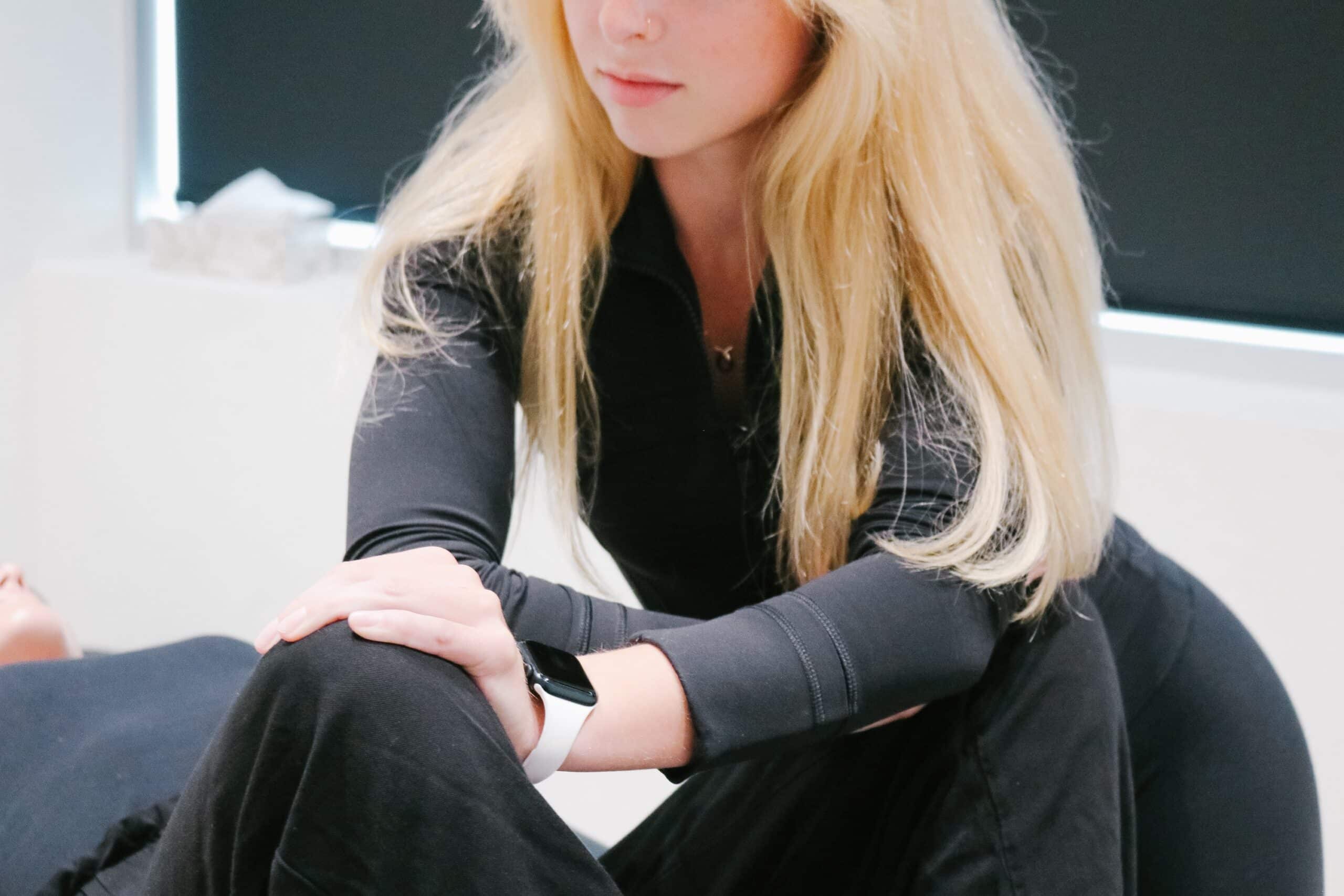 Close-up of a manual osteopath performing gentle treatment on a female patient to relieve tension and improve mobility at Stride Red Deer