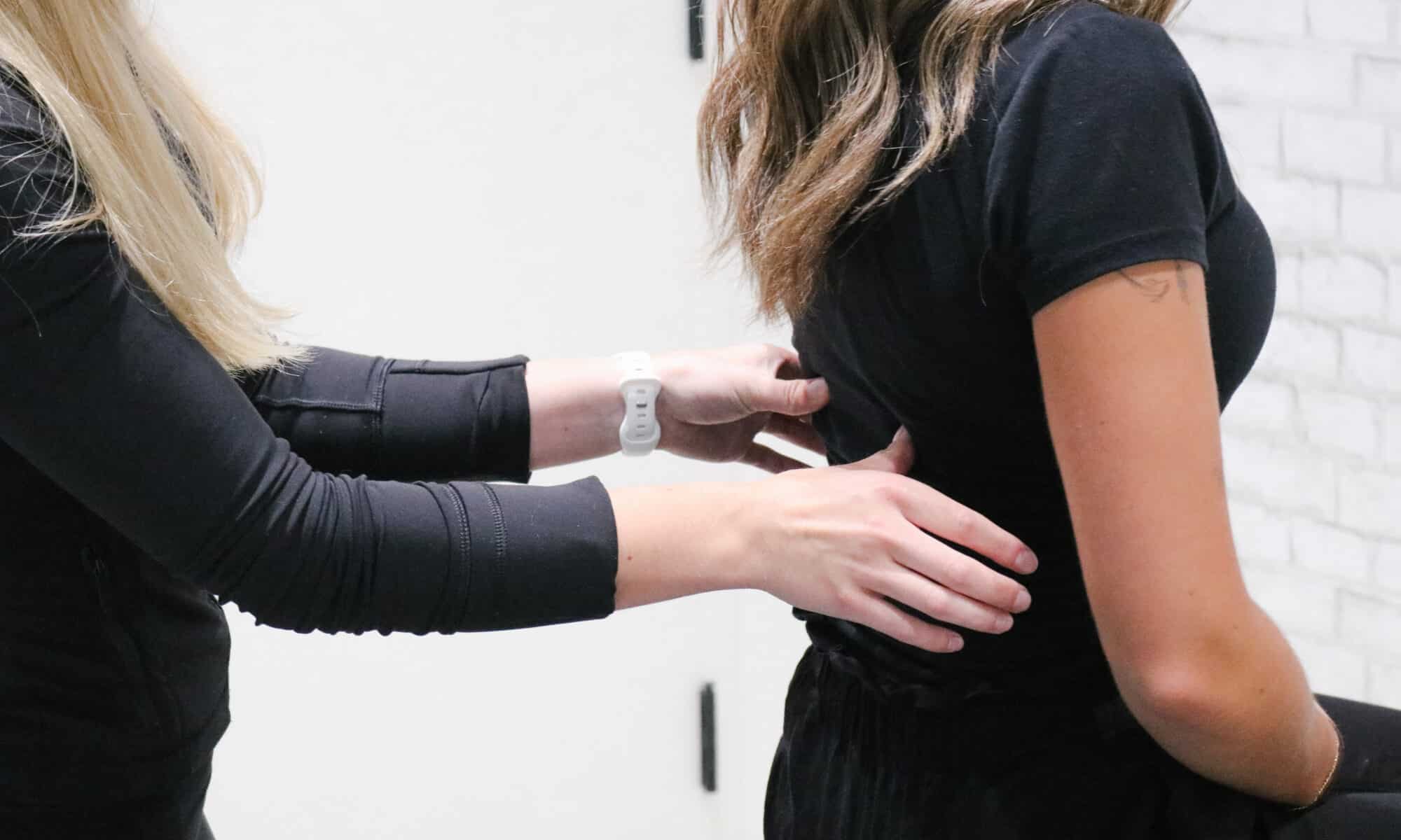 A practitioner providing manual osteopathy to help a female patient relieve tension and improve mobility at Stride Red Deer or Blackfalds clinic.